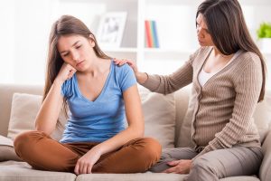 Mom consoling daughter