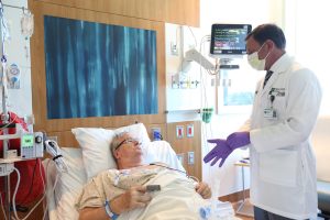 Dr. Guenther Koehne, Miami Cancer Institute, tending to patient